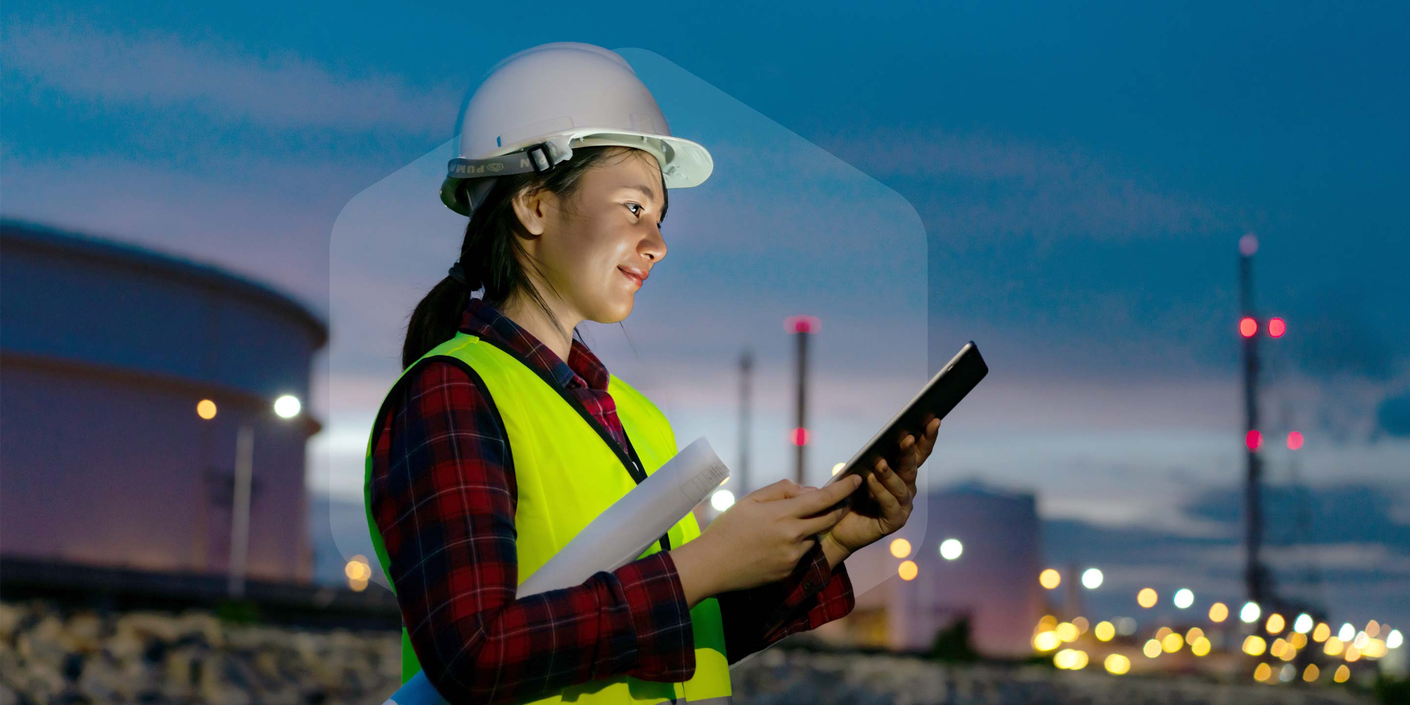 Asian woman petrochemical engineer working at night with digital tablet Inside oil and gas refinery plant industry factory at night for inspector safety quality control.
