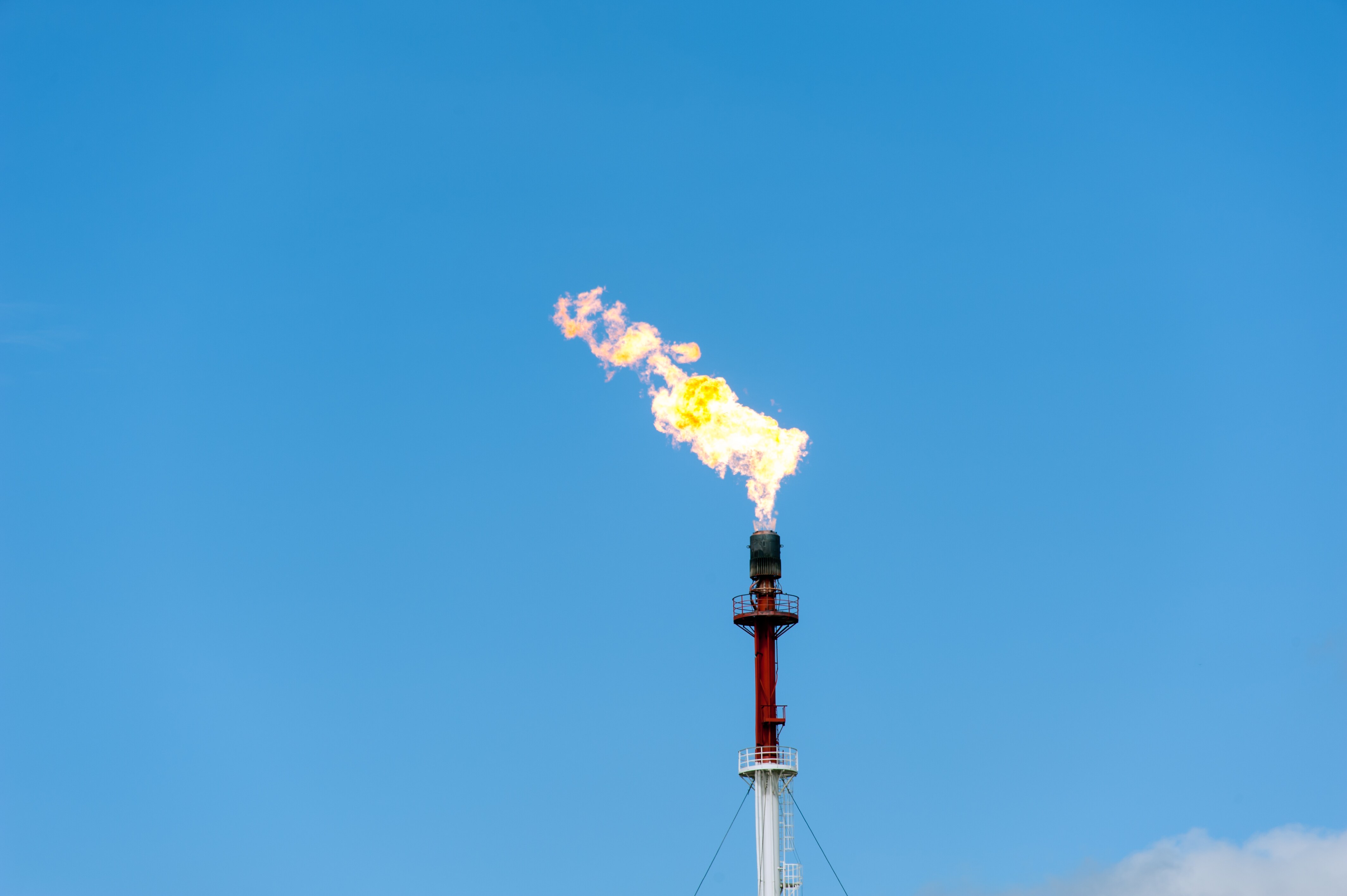 Torch on the blue sky background. Gas flaring.